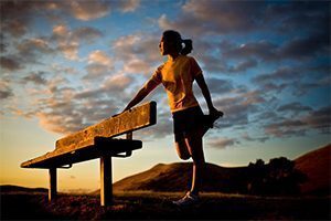 Woman Stretching at Sunset